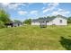 Expansive backyard with lush greenery, a trampoline, and an outbuilding at 80 Lewis Moody Rd, Bear Creek, NC 27207