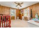 Bedroom with wood-paneled walls, ceiling fan, and natural light at 80 Lewis Moody Rd, Bear Creek, NC 27207