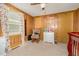 Another view of the wood-paneled bedroom with charming decor and a rocking chair at 80 Lewis Moody Rd, Bear Creek, NC 27207
