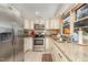 Bright eat-in kitchen featuring stainless steel appliances and granite countertops, with natural light from the windows at 80 Lewis Moody Rd, Bear Creek, NC 27207