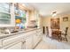 Eat-in kitchen featuring white cabinetry, granite countertops, and seamless access to the dining room at 80 Lewis Moody Rd, Bear Creek, NC 27207