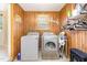 Laundry room with washer, dryer, overhead shelves, and laundry supplies at 80 Lewis Moody Rd, Bear Creek, NC 27207