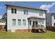 Back exterior view of two-story house, showing a small wooden deck and neutral vinyl siding at 808 Trinity Park Dr, Wake Forest, NC 27587