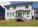 The home's back exterior features a small wooden deck and neutral vinyl siding at 808 Trinity Park Dr, Wake Forest, NC 27587