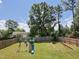 The large backyard includes a playset, ample space for activities, and a retaining wall at 808 Trinity Park Dr, Wake Forest, NC 27587