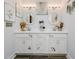 Elegant bathroom featuring a double sink vanity, decorative mirrors, and stylish lighting at 808 Trinity Park Dr, Wake Forest, NC 27587