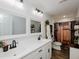 Bright bathroom featuring double sinks, framed mirrors, and a decorative ladder shelf at 808 Trinity Park Dr, Wake Forest, NC 27587