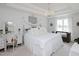 Charming bedroom with a decorative chandelier, white linens, canopy, and an elegant vanity at 808 Trinity Park Dr, Wake Forest, NC 27587