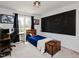 Cozy bedroom with a wooden desk, a black accent wall, and natural light from the window at 808 Trinity Park Dr, Wake Forest, NC 27587
