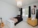This playful bedroom boasts football-themed decor, a cozy chair, and ample natural light at 808 Trinity Park Dr, Wake Forest, NC 27587