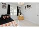 This bedroom features unique wall decor, a stylish light fixture, and a comfortable swivel chair at 808 Trinity Park Dr, Wake Forest, NC 27587