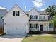 Charming two-story home featuring white siding, black shutters, and a welcoming front porch at 808 Trinity Park Dr, Wake Forest, NC 27587