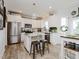 Stylish kitchen showcasing white cabinets, granite countertops, stainless steel appliances, and breakfast bar seating at 808 Trinity Park Dr, Wake Forest, NC 27587