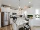 Well-appointed kitchen features a large island, stainless steel appliances, and ample white cabinet space at 808 Trinity Park Dr, Wake Forest, NC 27587