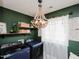 Modern laundry room featuring stylish lighting, open shelving, and updated washer and dryer at 808 Trinity Park Dr, Wake Forest, NC 27587