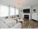 Comfortable living room showcasing a fireplace, chandelier, and a cozy sectional sofa at 808 Trinity Park Dr, Wake Forest, NC 27587