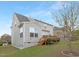Well-maintained backyard featuring a deck, green lawn, and a neatly landscaped perimeter with young trees and shrubs at 844 Cozy Oak Ave, Cary, NC 27519