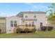 Expansive backyard with a wooden deck and steps leading to a green lawn at 844 Cozy Oak Ave, Cary, NC 27519