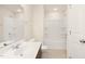 Well-lit bathroom with a white shower-tub combo, and a vanity with a white sink at 844 Cozy Oak Ave, Cary, NC 27519