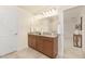 Bathroom with a double sink vanity with wood cabinets and a large mirror with great lighting at 844 Cozy Oak Ave, Cary, NC 27519