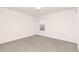 A vacant bedroom with neutral carpet, a window, and simple fixtures at 844 Cozy Oak Ave, Cary, NC 27519