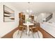 Inviting dining area near the kitchen, with hardwood floors, and a decorative light fixture at 844 Cozy Oak Ave, Cary, NC 27519