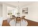 Bright dining room area featuring a round table, stylish chairs, and large windows at 844 Cozy Oak Ave, Cary, NC 27519
