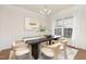 Elegant dining room with dark wood table, modern chairs, and natural light at 844 Cozy Oak Ave, Cary, NC 27519