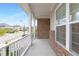View from covered front porch with white railings overlooking the street and neighboring homes at 844 Cozy Oak Ave, Cary, NC 27519