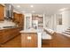 Open kitchen features granite countertops, stainless steel appliances, and a breakfast bar area at 844 Cozy Oak Ave, Cary, NC 27519