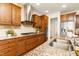 Contemporary kitchen showcasing stainless steel appliances, granite counters, and wooden cabinetry at 844 Cozy Oak Ave, Cary, NC 27519
