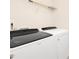 Modern laundry room featuring a Whirlpool washer and dryer, complemented by a wire rack for convenient storage at 844 Cozy Oak Ave, Cary, NC 27519