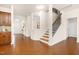 Open-concept living area with hardwood flooring, staircase, and bright natural lighting at 844 Cozy Oak Ave, Cary, NC 27519