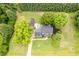 An aerial view of a beautiful home with a lush green yard, mature trees and a detached garage at 8517 Falkirk Ridge Ct, Wake Forest, NC 27587