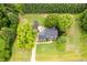 Overview of a landscaped property featuring a well-maintained home, garden, and sprawling lawn at 8517 Falkirk Ridge Ct, Wake Forest, NC 27587