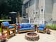 Backyard patio area with a fire pit, seating, a grill, and attractive landscaping, creating a cozy outdoor living space at 8517 Falkirk Ridge Ct, Wake Forest, NC 27587