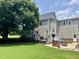 An inviting backyard with a patio featuring comfortable seating, lush landscaping, and a fire pit area at 8517 Falkirk Ridge Ct, Wake Forest, NC 27587