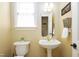 Charming half bathroom featuring a pedestal sink, decorative mirror and toilet at 8517 Falkirk Ridge Ct, Wake Forest, NC 27587