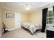 Well lit bedroom featuring a twin bed, ceiling fan and carpeted floors at 8517 Falkirk Ridge Ct, Wake Forest, NC 27587