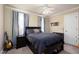 Neutral bedroom featuring a black bed frame, ceiling fan, carpeted floors and natural light at 8517 Falkirk Ridge Ct, Wake Forest, NC 27587
