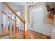 Bright entryway featuring hardwood floors, a staircase, and a front door with sidelight at 8517 Falkirk Ridge Ct, Wake Forest, NC 27587