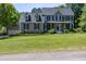 Charming home with a well-manicured lawn, mature trees, and a detached garage at 8517 Falkirk Ridge Ct, Wake Forest, NC 27587