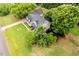 Aerial view of a well-maintained home with a long driveway and a lush, landscaped front yard at 8517 Falkirk Ridge Ct, Wake Forest, NC 27587