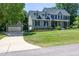 Traditional home with a well-manicured lawn, mature trees, and a detached garage at 8517 Falkirk Ridge Ct, Wake Forest, NC 27587