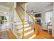 Inviting staircase foyer with hardwood floors and views into the adjacent living spaces at 8517 Falkirk Ridge Ct, Wake Forest, NC 27587