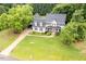 Inviting two-story home with manicured lawn and mature trees offering shade and beauty at 8517 Falkirk Ridge Ct, Wake Forest, NC 27587