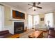 Cozy living room with a fireplace, hardwood floors, and natural light from large windows at 8517 Falkirk Ridge Ct, Wake Forest, NC 27587