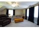 Carpeted living room area featuring a sofa, chair, table, ceiling fan and natural light at 8517 Falkirk Ridge Ct, Wake Forest, NC 27587