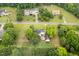 Aerial view showcasing a residential street with mature trees and well-maintained homes at 8517 Falkirk Ridge Ct, Wake Forest, NC 27587