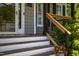 A close-up of the porch steps leads to the front door, surrounded by landscaping at 8517 Falkirk Ridge Ct, Wake Forest, NC 27587
